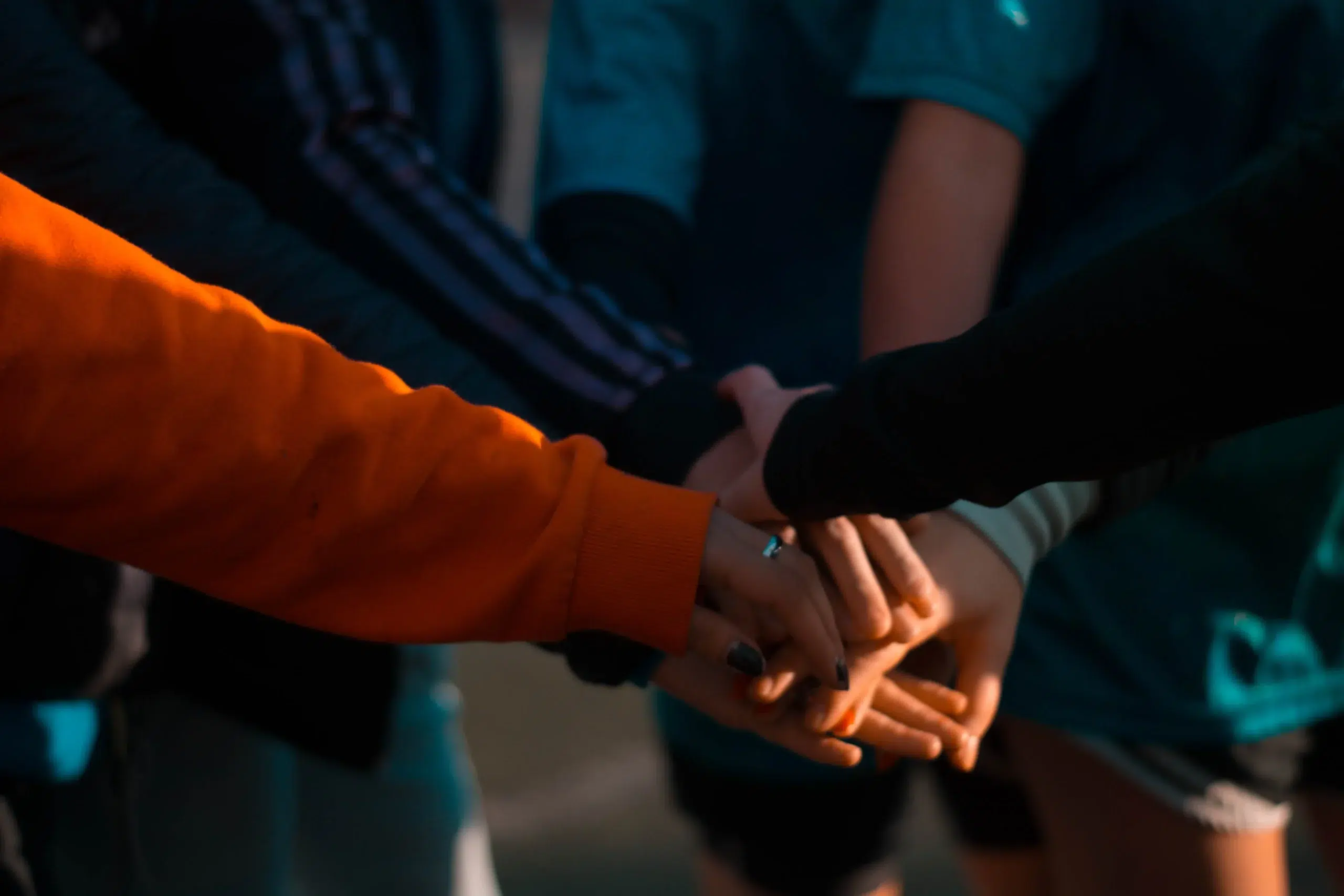 team stacking their hands in a circle