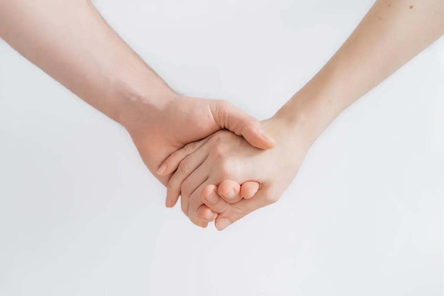 Close up of two people holding hands