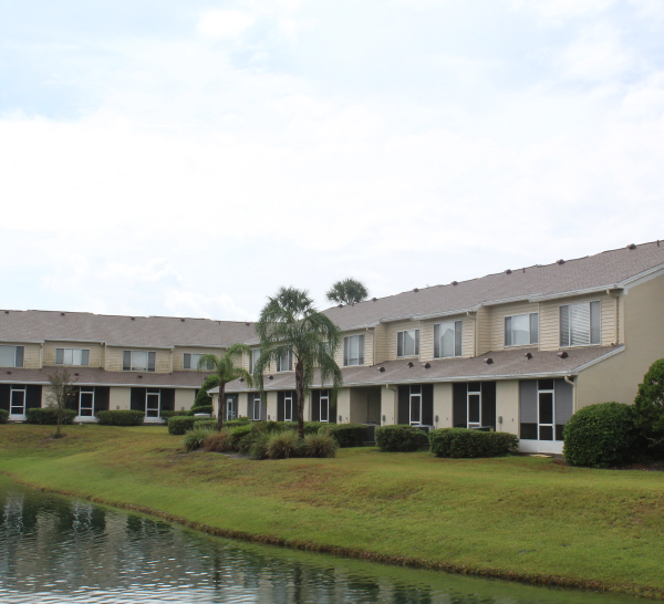 Apartment complex in front of a pond