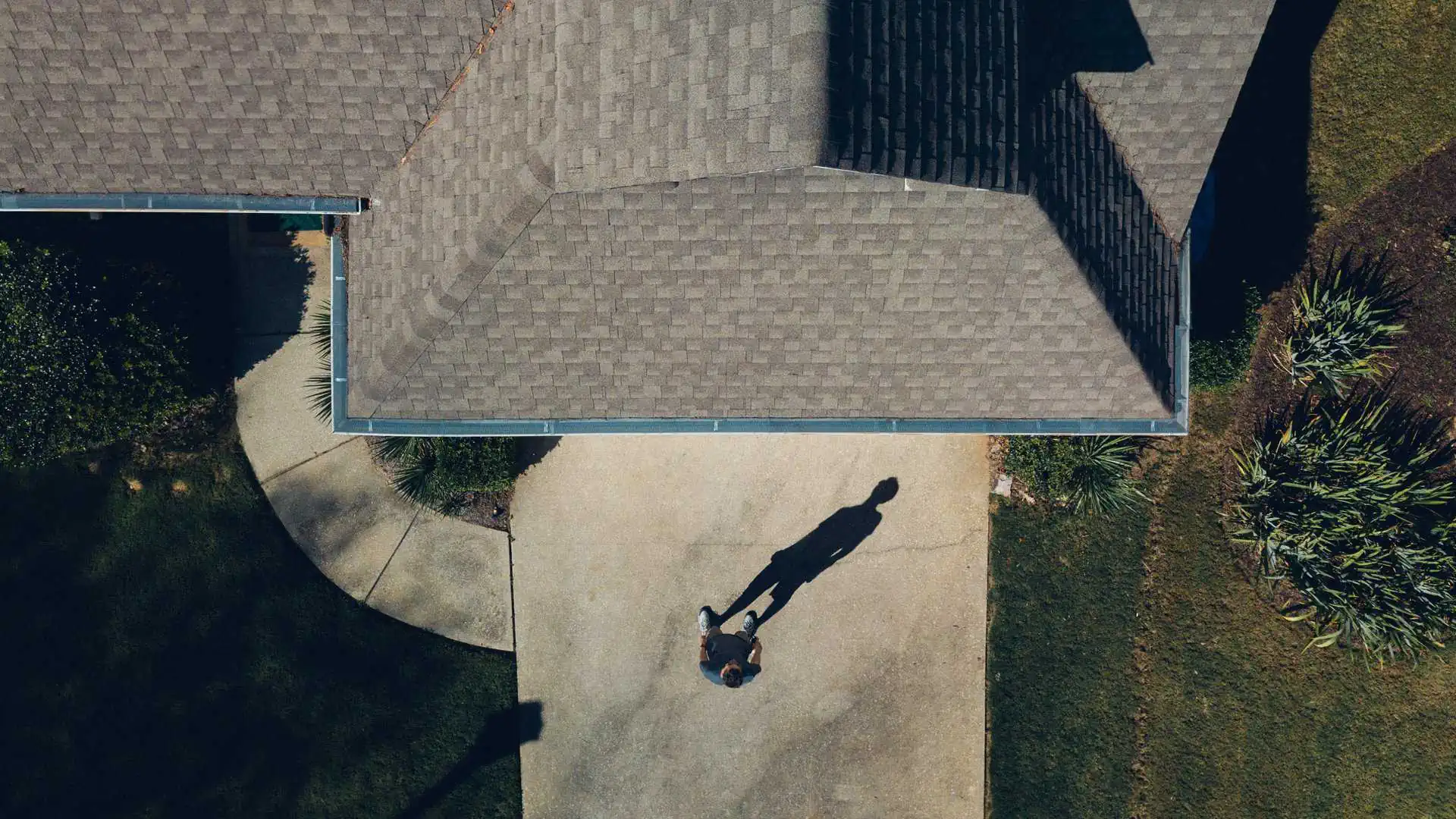 Top down view of a man standing in front of his home