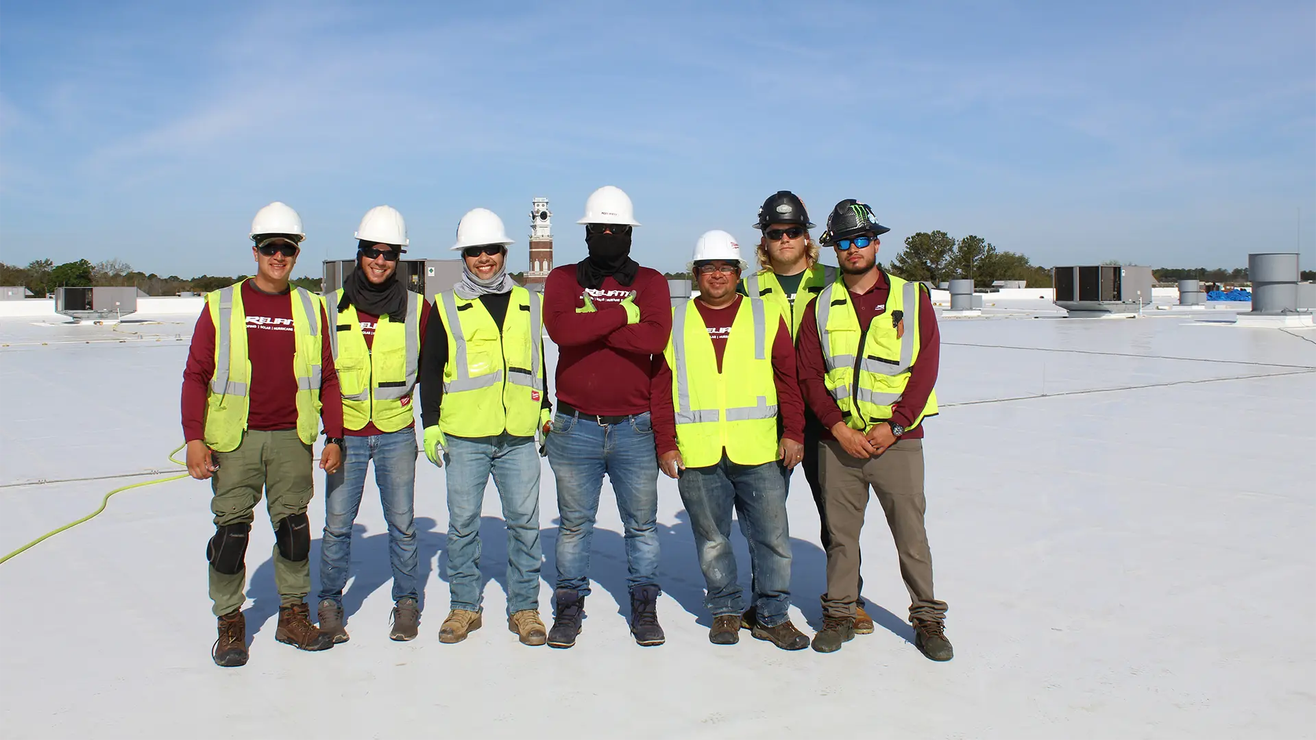 Group photo of construction workers on a rooftop
