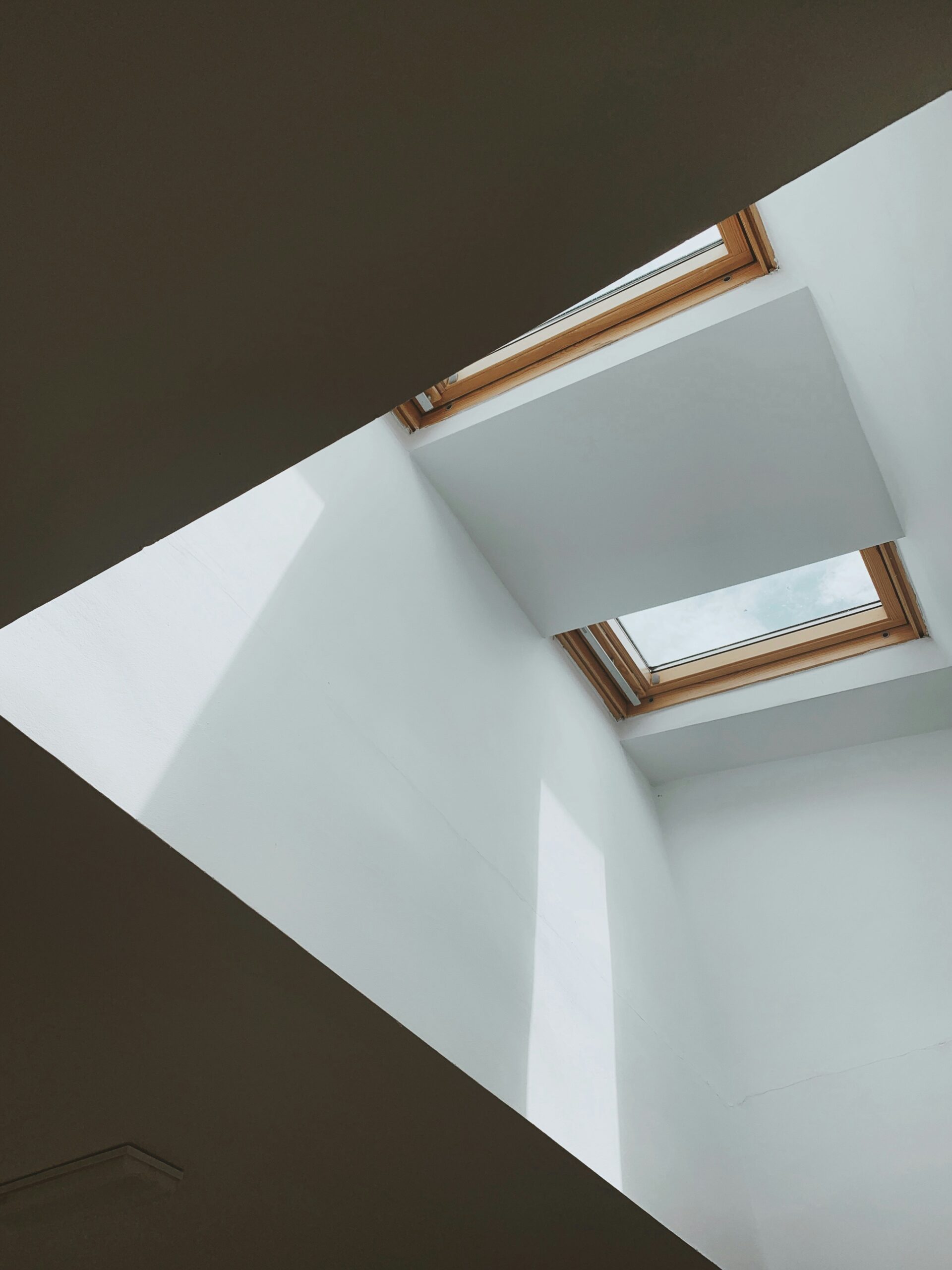 Two skylights with wooden trim on ceiling